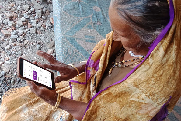 Elderly Lady Using FINTAP app on cellphone